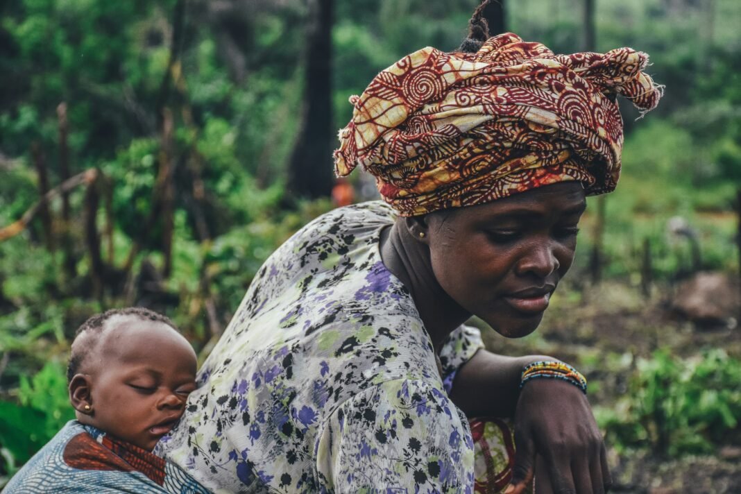 African mother carrying her baby on her back