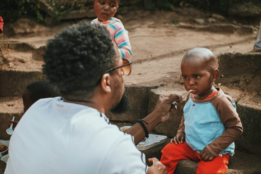 African mother holding and caring for her young child